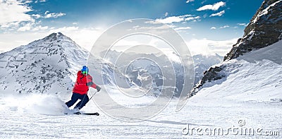 Man skiing on the prepared slope with fresh new powder snow in A Stock Photo