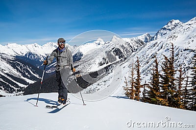 Man skiing uphill near the Asulkan Glacier in Roger`s Pass area of Glacier National Park, Canada. Skier going uphill skinning, Stock Photo