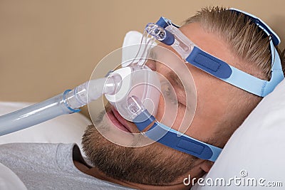 Man With Sleeping Apnea And CPAP Machine Stock Photo
