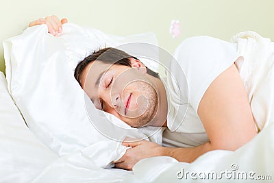 Man sleeping in bed Stock Photo