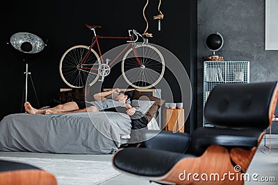 Monochromatic bedroom with sleeping man Stock Photo