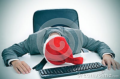 Man sleeping in the office after a christmas party Stock Photo