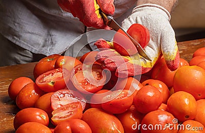 a man slices tomatoes Stock Photo