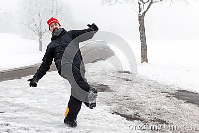 Man is slipping on a icy road Stock Photo