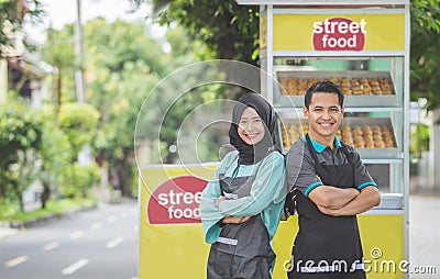 Man with small business food stall Stock Photo