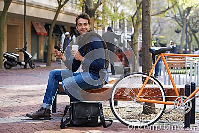 Man, smartphone and coffee and bike for travel and carbon footprint, communication and cycling outdoor. Eco friendly Stock Photo