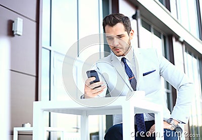 Man on smartphone - young business man talking on smart phone. Casual urban professional businessman using mobile cell Stock Photo