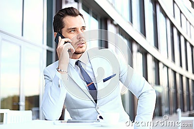 Man on smartphone - young business man talking on smart phone. Casual urban professional businessman using mobile cell Stock Photo