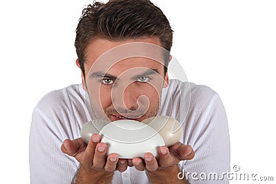 Man smelling bars of soap Stock Photo