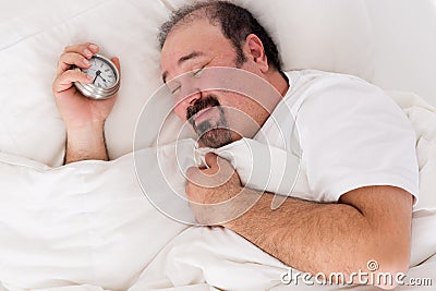 Man smiling in contentment after a good sleep Stock Photo