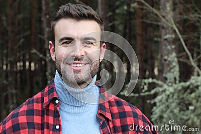 Man smiling in a winter looking forest Stock Photo
