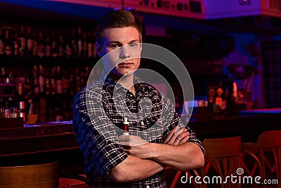 The man smoke an electronic cigarette at the vape shop. Stock Photo