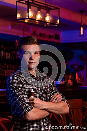 The man smoke an electronic cigarette at the vape shop. Stock Photo