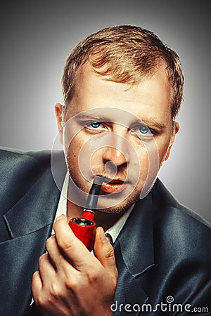 A man smokes a pipe Stock Photo