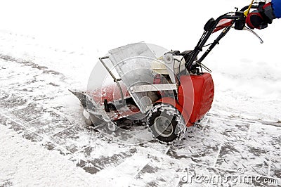 Man and a snow blowing machine Stock Photo