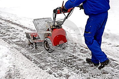 Man and a snow blowing machine Stock Photo