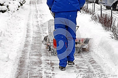 Man and a snow blowing machine Stock Photo