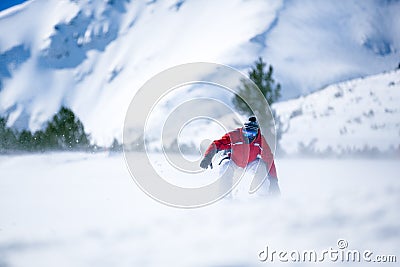 Man snowboarding down hill Stock Photo