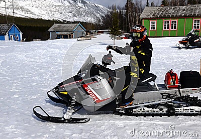 The man and snowmobile on the rescue station Editorial Stock Photo