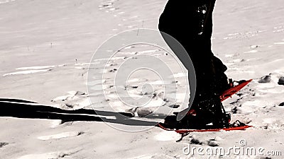 Man snowshoeing with orange snowshoes in winter with special ef Stock Photo