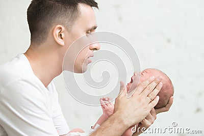 Man soothing a screaming newborn Stock Photo