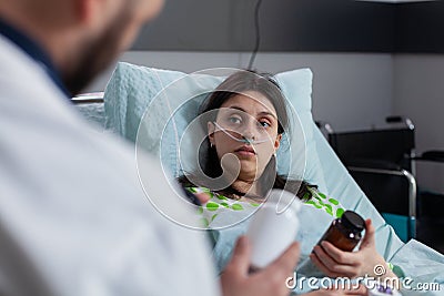 Man specialist doctor explaining pills treatment against pain during clinic appointment Stock Photo