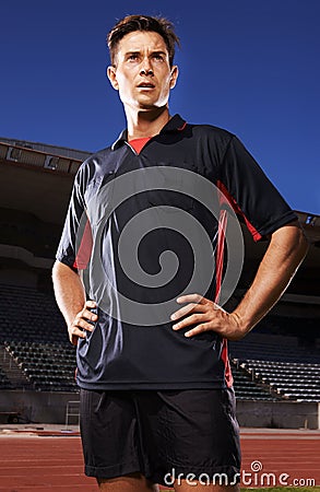 Man, sports and confident soccer player in stadium, athlete and competitive for match or game. Male person, serious face Stock Photo