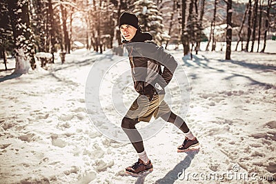 Man Taking Break From Running in Extreme Snow Conditions Stock Photo