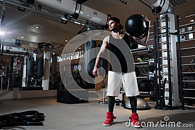 Man in sportswear is training in the gym Stock Photo