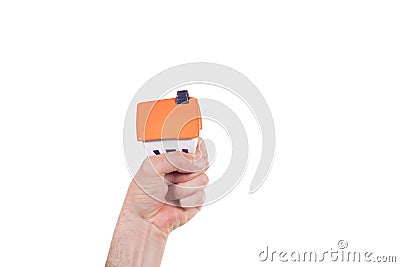 Man squeezing a small house model in his hand Stock Photo