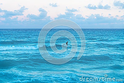 Man stand surfing in the ocean during sunset at Cancun, Yucatan, Mexico Stock Photo
