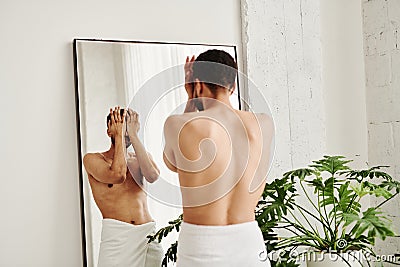 Man standing in bathroom in morning Stock Photo