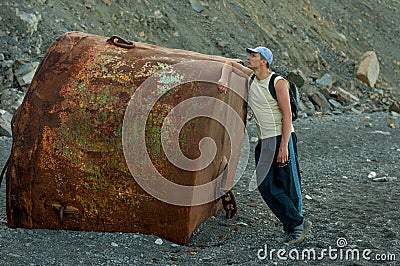 Man standing on the beach near the buoy Stock Photo
