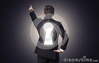 Man standing with black keyhole on his back Stock Photo