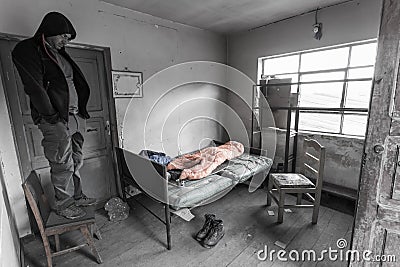 Man standing chair old room poor abandoned, frustration b&w emotion. Stock Photo