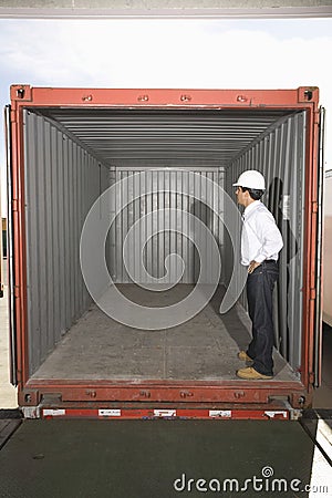 Man Standing In Empty Container Stock Photo