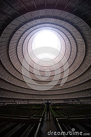 Man standing in an empty hall with a round window on the ceiling Editorial Stock Photo