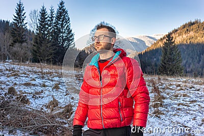 Man hiking on mountain with Insulation during winter Stock Photo