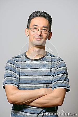 Man standing with folded hands Stock Photo