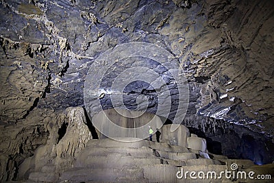 Man standing on a group of stalactite cave 3 Stock Photo
