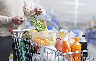 Man checking the grocery receipt Stock Photo