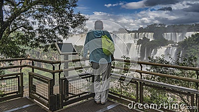 A man is standing on the observation deck, leaning on the railing Editorial Stock Photo