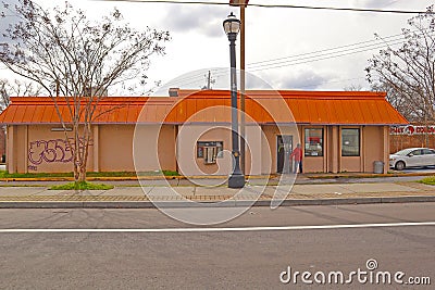 Man standing outside of an urban fast food restaurant Editorial Stock Photo