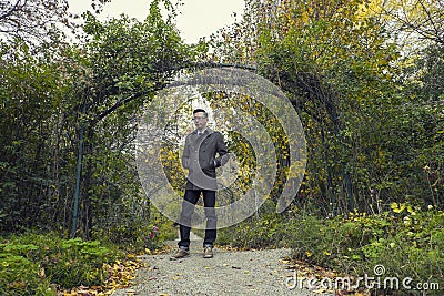 Man standing in park in fall season / autumn Stock Photo