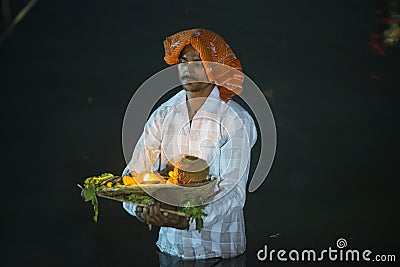 Man standing in river water at chhat puja Editorial Stock Photo