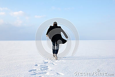 Man standing on the shore of a frozen sea downshifting way relax Stock Photo