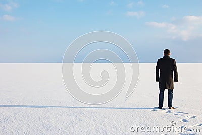 Man standing on the shore of a frozen sea downshifting way relax Stock Photo