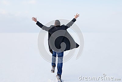 Man standing on the shore of a frozen sea downshifting way relax Stock Photo