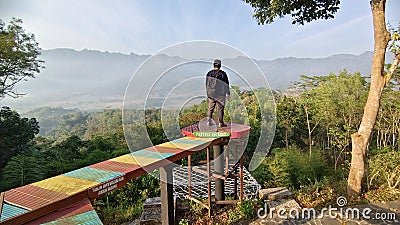 A man standing in the View point and selfie photo spot in Punthuk Setumbu Hills, Magelang, Central Java Stock Photo