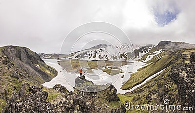 Man standing on volcanic with view on snowy volcanoes Stock Photo